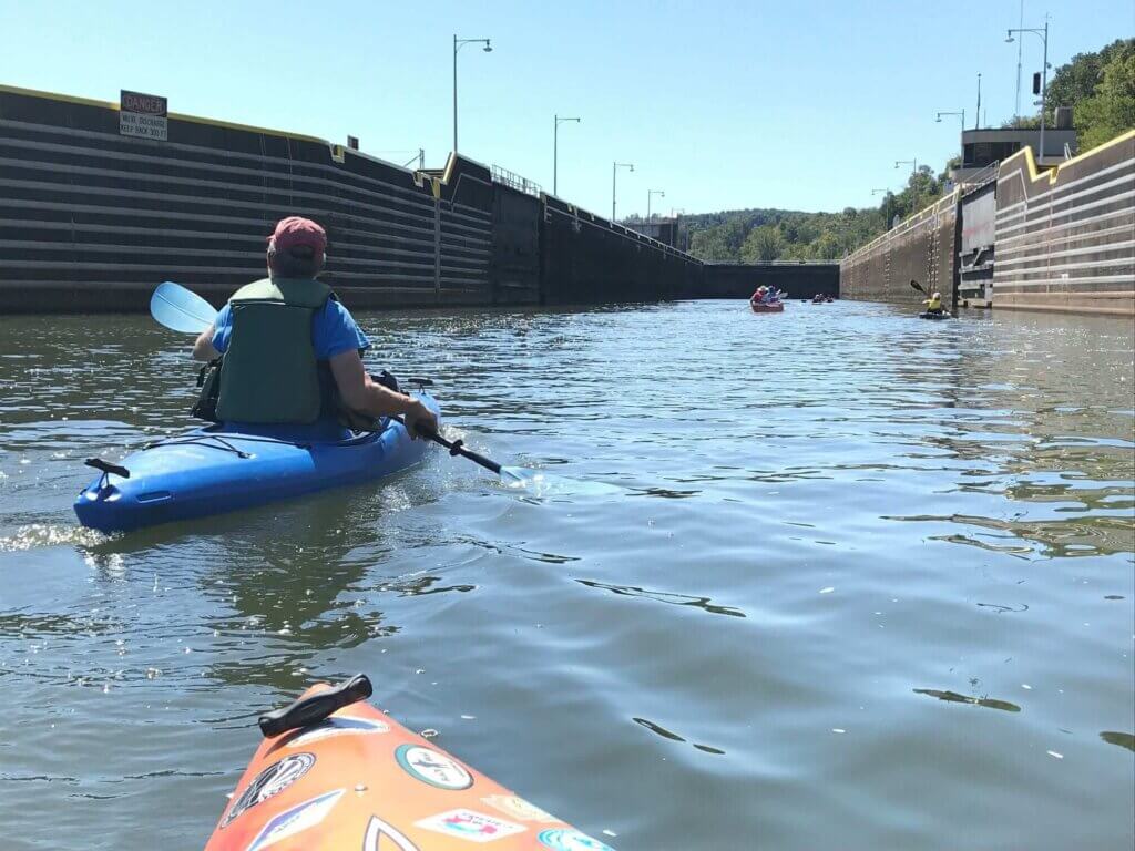 Kayakers move through locks on Mon River