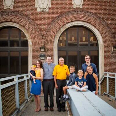 Family stands in front of Stansbury hall in Morgantown