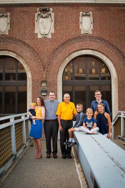 Family stands in front of Stansbury hall in Morgantown